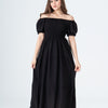Woman wearing a black off-shoulder dress on a white background