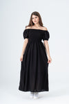 Woman wearing a black off-shoulder dress on a white background
